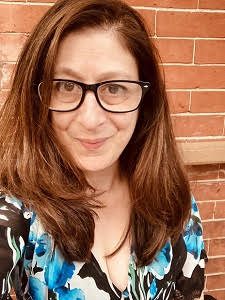 Headshot photo of Amy Wolfe. She's wearing glasses and looking at the camera.